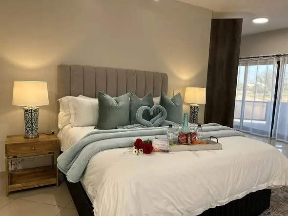 A king bed dressed for arrival