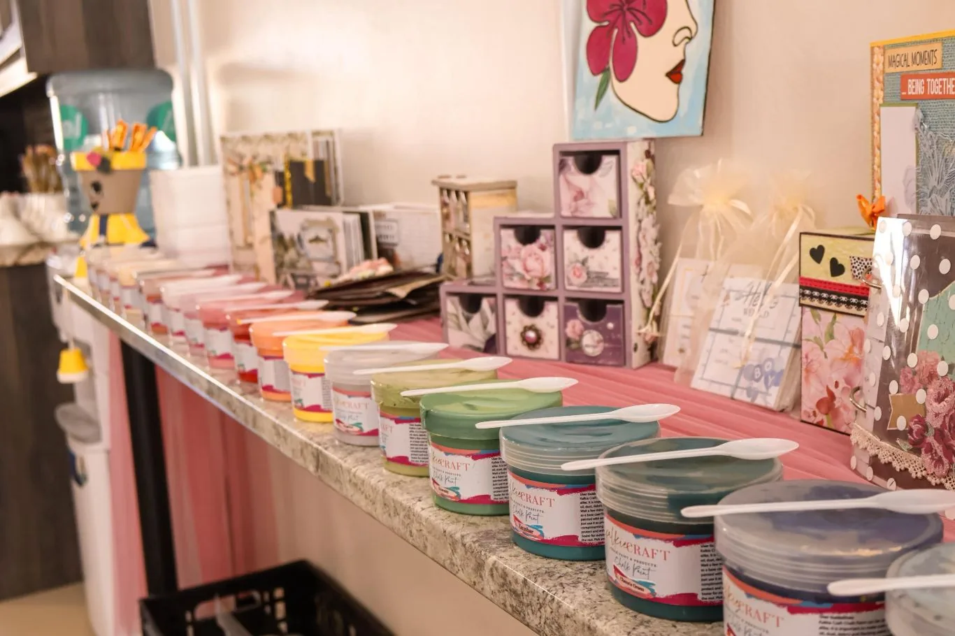 Chalk paints and craft supplies laid out for guests