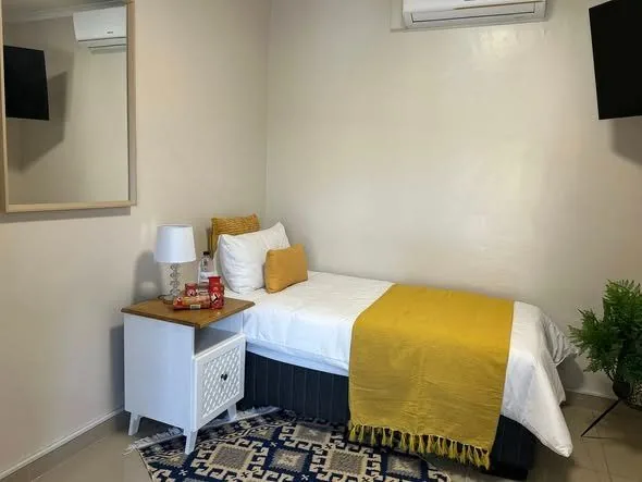 A single room with a yellow throw